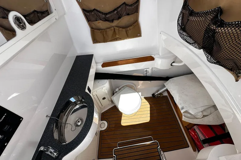  Yacht Photos Pics 2022 Southport 30 FE boat interior with sink, toilet, and storage compartments.