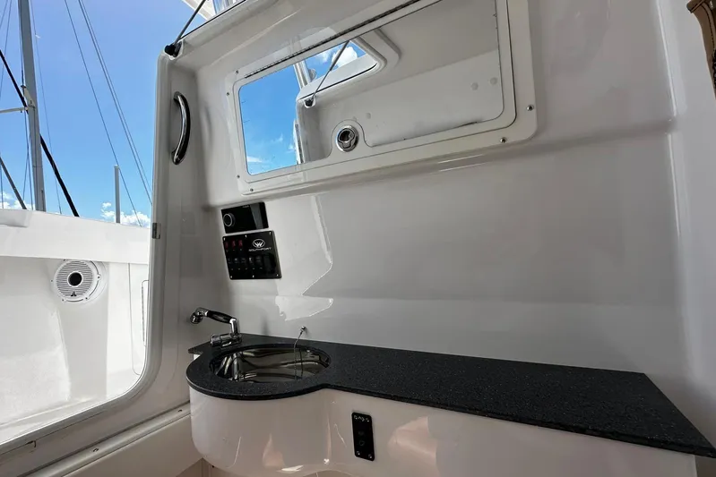  Yacht Photos Pics Interior view of 2022 Southport 30 FE boat with sink and control panel.