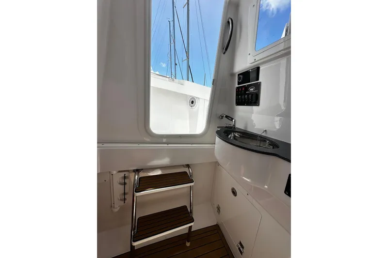  Yacht Photos Pics Interior view of 2022 Southport 30 FE boat with sink and steps.