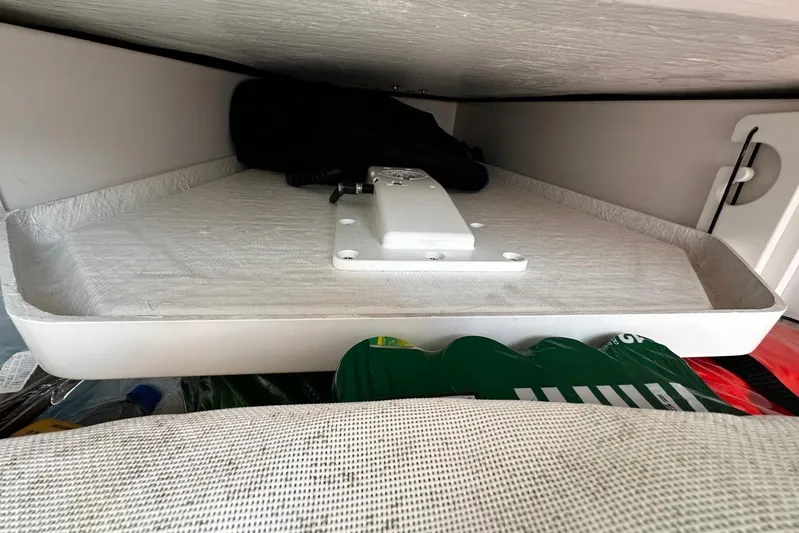  Yacht Photos Pics Storage compartment in a 2022 Southport 30 FE boat, featuring organized interior space.