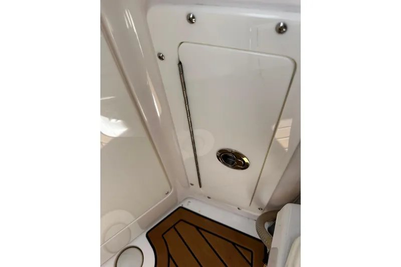  Yacht Photos Pics 2022 Southport 30 FE interior detail with sleek white panel and wood-patterned flooring.