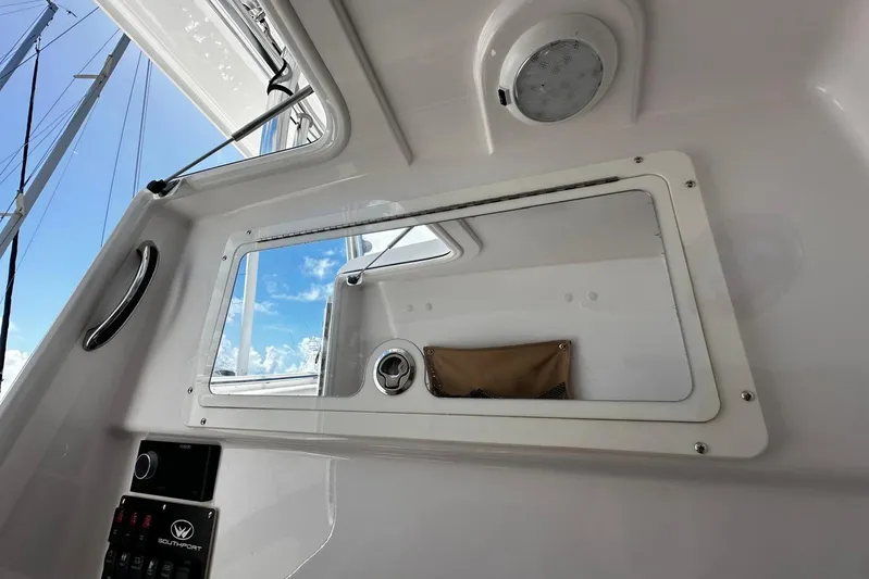  Yacht Photos Pics Interior view of 2022 Southport 30 FE boat, featuring a window and control panel.