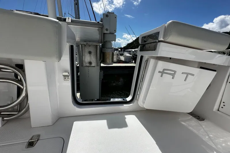  Yacht Photos Pics 2022 Southport 30 FE boat interior with open hatch and seating, under a clear sky.