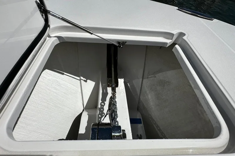  Yacht Photos Pics Anchor compartment of 2022 Southport 30 FE boat, open with visible chain and mechanism.