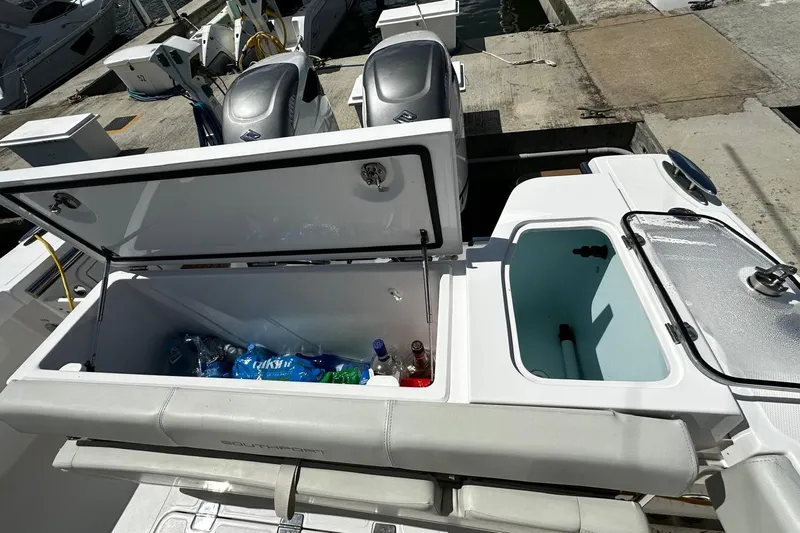  Yacht Photos Pics 2022 Southport 30 FE boat with open storage compartments and visible beverages.