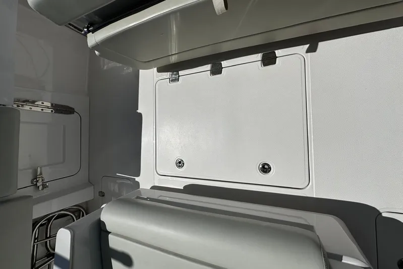  Yacht Photos Pics 2022 Southport 30 FE boat interior with storage compartment and seating.