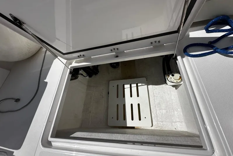  Yacht Photos Pics Open storage compartment on a 2022 Southport 30 FE boat, featuring a blue rope.