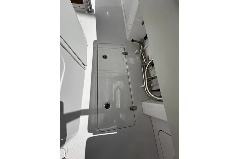  Yacht Photos Pics 2022 Southport 30 FE boat interior with storage compartment and stainless steel fixtures.