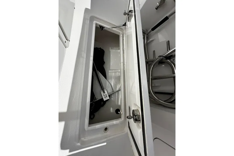  Yacht Photos Pics Open storage compartment on a 2022 Southport 30 FE boat, showcasing interior details.