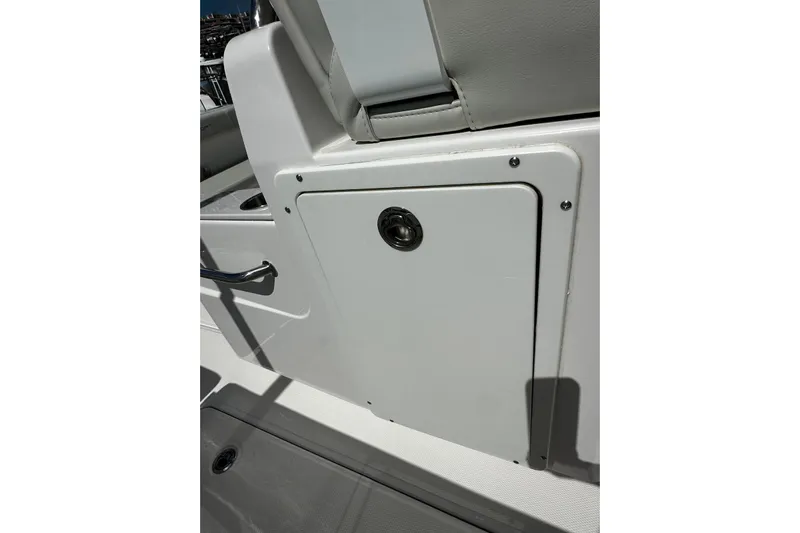  Yacht Photos Pics 2022 Southport 30 FE boat storage compartment with sleek design and secure latch.