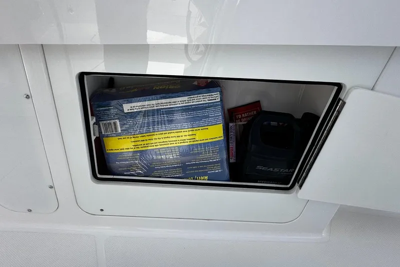  Yacht Photos Pics Storage compartment on a 2022 Southport 30 FE boat, containing various items.