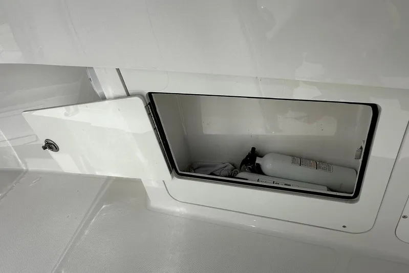  Yacht Photos Pics Storage compartment on a 2022 Southport 30 FE boat with fire extinguisher.
