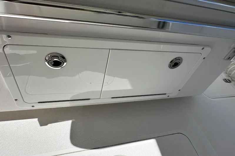  Yacht Photos Pics Storage compartment on a 2022 Southport 30 FE boat, featuring sleek design and stainless steel accents.