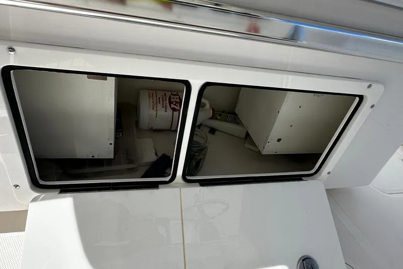  Yacht Photos Pics Storage compartments on a 2022 Southport 30 FE boat, featuring organized interior space.