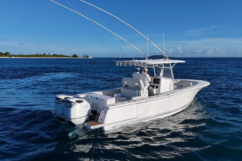  Yacht Photos Pics 2022 Southport 30 FE boat cruising on open water under clear blue skies.