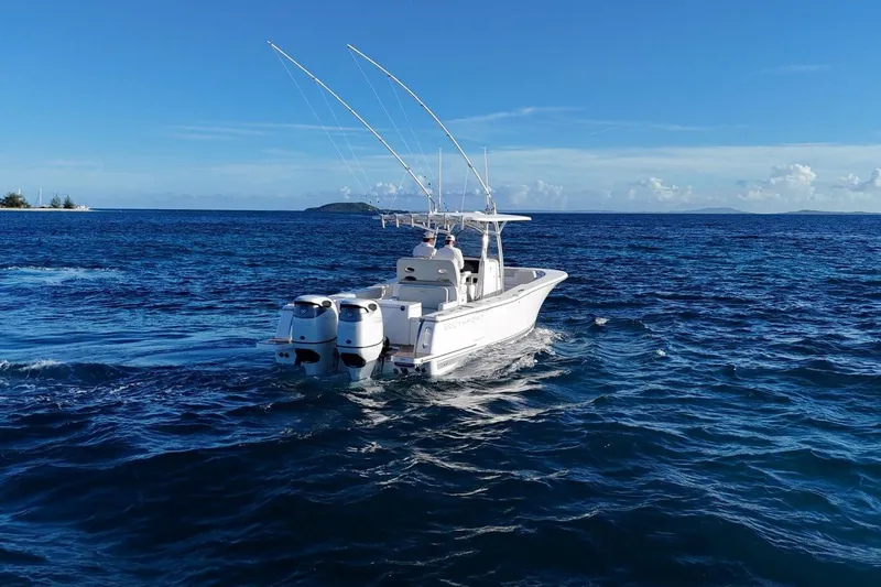  Yacht Photos Pics 2022 Southport 30 FE boat cruising on open ocean under clear blue sky.
