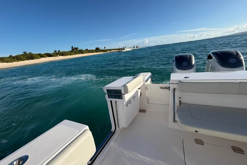  Yacht Photos Pics 2022 Southport 30 FE boat on ocean near sandy beach and clear blue sky.