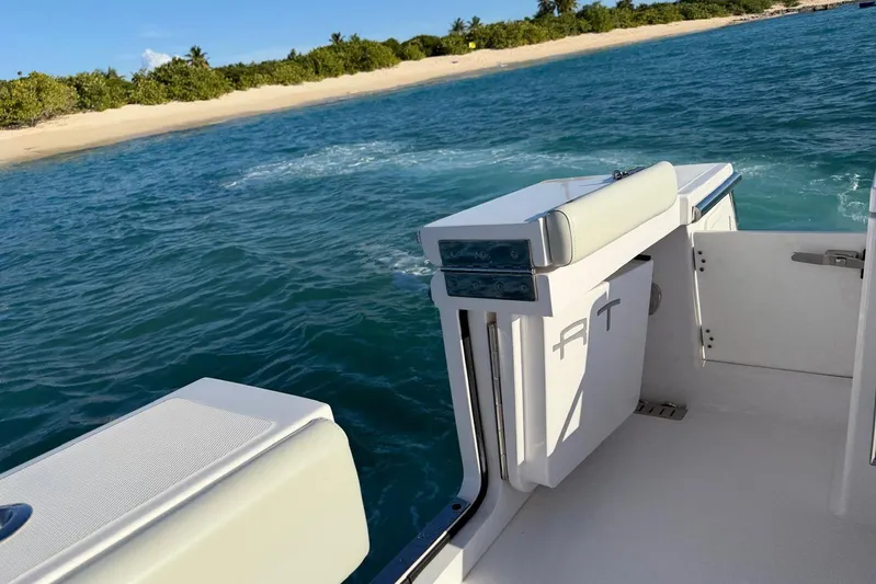  Yacht Photos Pics 2022 Southport 30 FE boat near tropical beach with clear blue water.