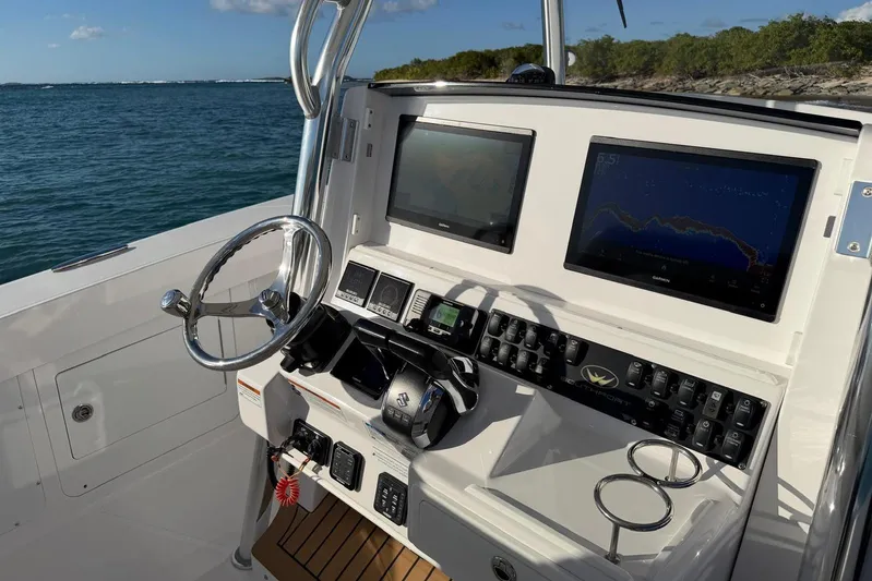  Yacht Photos Pics 2022 Southport 30 FE boat dashboard with navigation screens and controls.