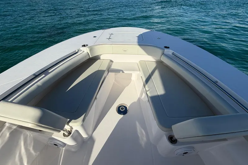  Yacht Photos Pics 2022 Southport 30 FE boat interior with cushioned seating, on calm blue water.