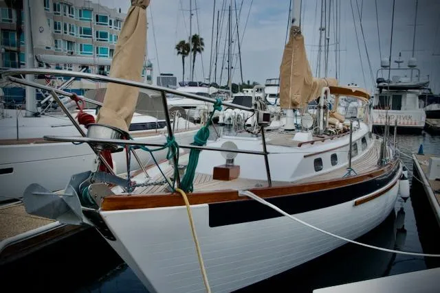 Sara Yacht Photos Pics Sailboat docked at marina, Passport 42 model, 1986, with covered sails and wooden accents.