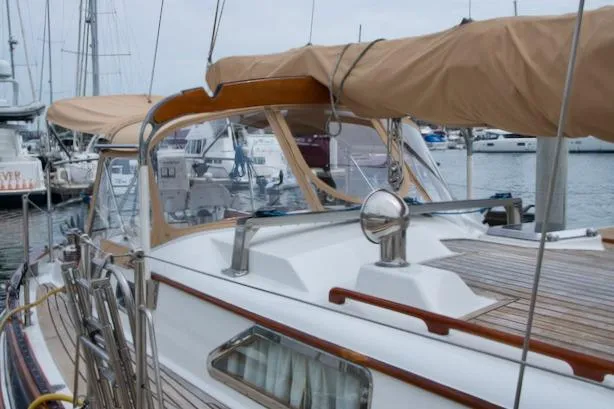 Sara Yacht Photos Pics Sailboat docked in marina, Passport 42 model, 1986, with tan canvas cover.