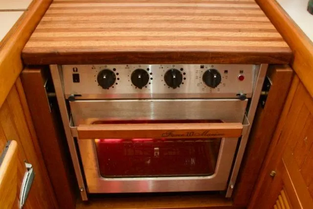 Sara Yacht Photos Pics Vintage 1986 Passport 42 oven with wooden countertop and control knobs.
