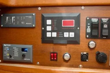 Sara Yacht Photos Pics Control panel of a 1986 Passport 42 yacht with various switches and displays.