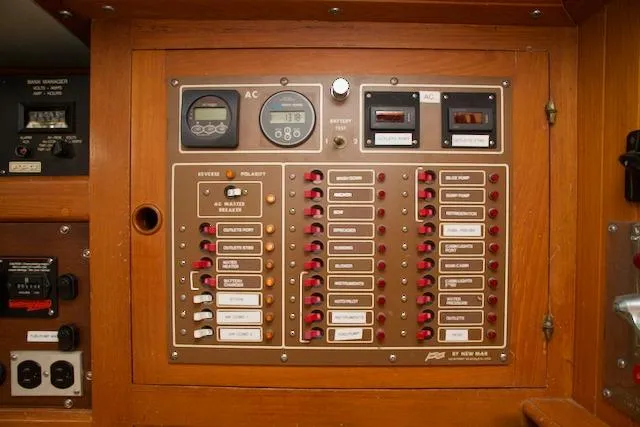 Sara Yacht Photos Pics Electrical control panel on a 1986 Passport 42 boat, featuring switches and meters.