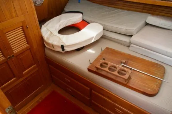Sara Yacht Photos Pics Cozy cabin interior of 1986 Passport 42 sailboat with life preserver and wooden tray.