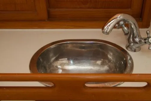 Sara Yacht Photos Pics Stainless steel sink with faucet in 1986 Passport 42 model kitchen.