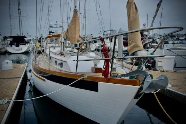 Sara Yacht Photos Pics Sailboat docked in marina, Passport 42 model, 1986, with wooden deck and covered sails.