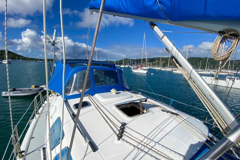  Yacht Photos Pics Sailboat Hunter 41 DS 2006 on water, blue canopy, marina background, sunny day.