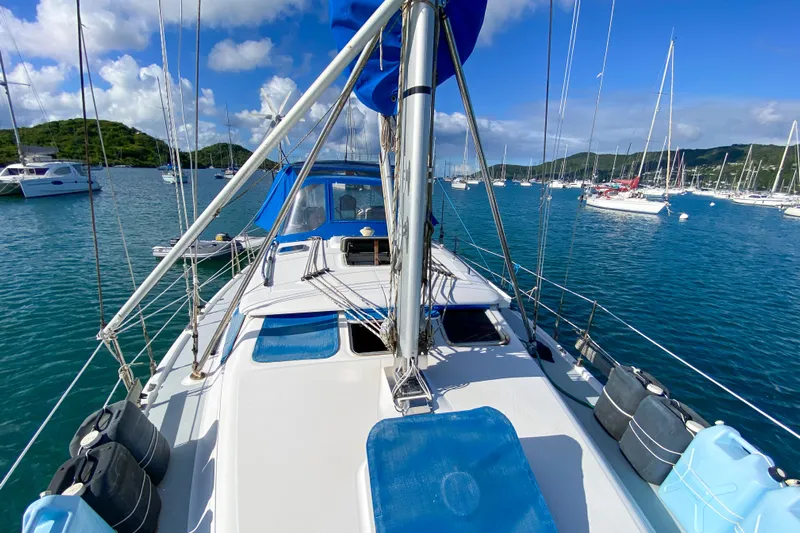  Yacht Photos Pics 2006 Hunter 41 DS sailboat on calm waters, surrounded by other boats and lush green hills.