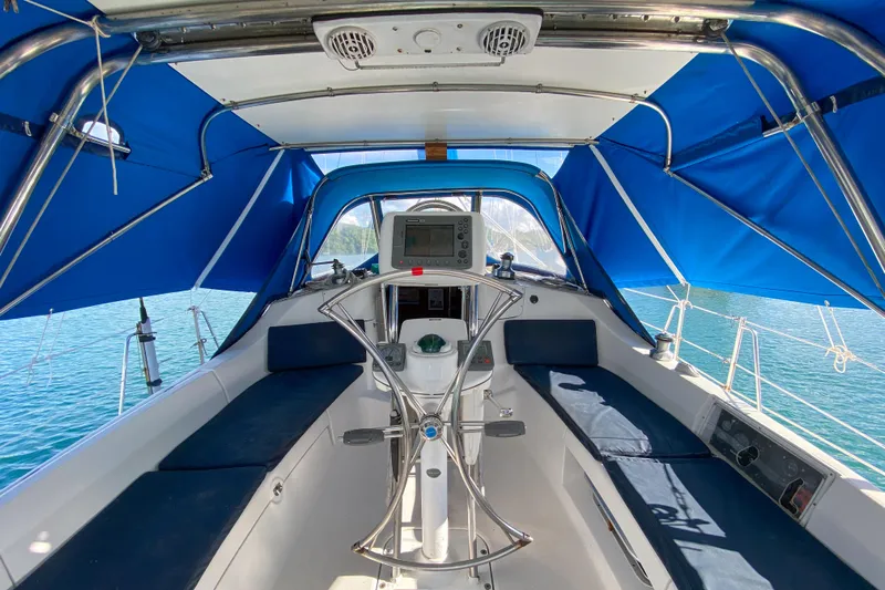  Yacht Photos Pics 2006 Hunter 41 DS sailboat cockpit with blue canopy and steering wheel.