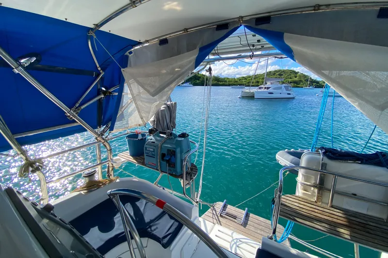  Yacht Photos Pics Hunter 41 DS sailboat cockpit view, anchored in serene turquoise waters, 2006 model.