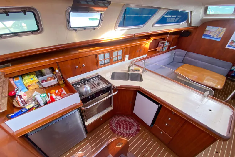  Yacht Photos Pics Interior of 2006 Hunter 41 DS sailboat with kitchen and seating area.