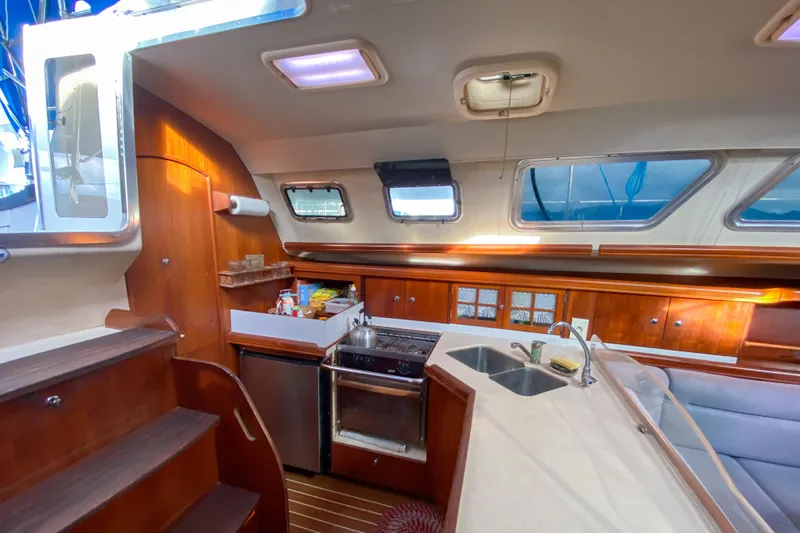  Yacht Photos Pics Interior of 2006 Hunter 41 DS sailboat with modern kitchen and seating area.