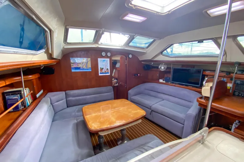  Yacht Photos Pics Interior of 2006 Hunter 41 DS sailboat with spacious seating and wooden table.
