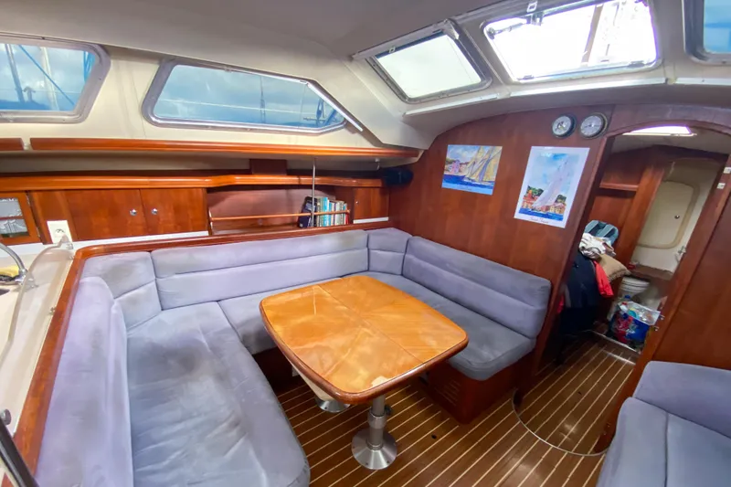  Yacht Photos Pics Interior of 2006 Hunter 41 DS sailboat with cozy seating and wooden table.
