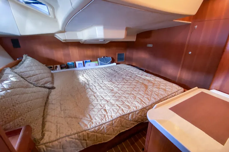  Yacht Photos Pics Luxurious cabin interior of 2006 Hunter 41 DS yacht with cozy bedding and wooden finish.
