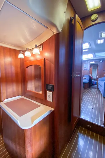  Yacht Photos Pics Interior of 2006 Hunter 41 DS sailboat with wooden cabinetry and modern lighting.