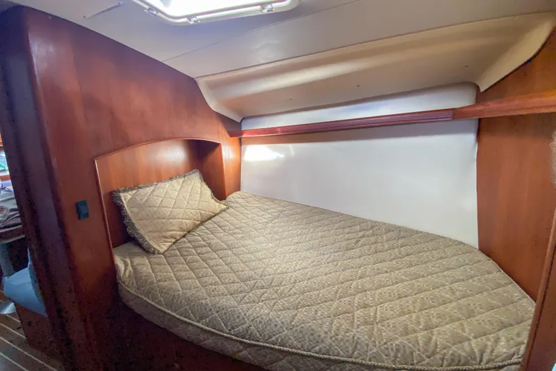  Yacht Photos Pics Cozy cabin bed in 2006 Hunter 41 DS sailboat with wooden interior.