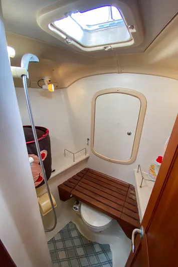  Yacht Photos Pics 2006 Hunter 41 DS yacht bathroom with shower, toilet, and wooden bench.