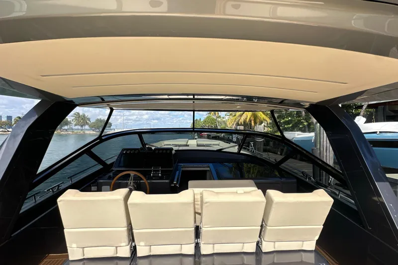Yanina Yacht Photos Pics Interior view of 2019 CNM 54 yacht with modern seating and steering wheel.