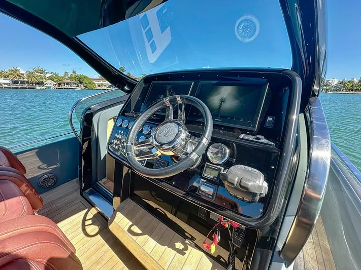 B-offline Yacht Photos Pics 2019 SACS Rebel 40 helm with modern controls, steering wheel, and scenic water view.