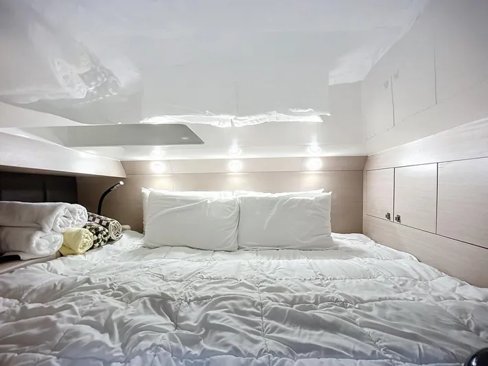 B-offline Yacht Photos Pics Luxurious cabin interior of 2019 SACS Rebel 40 with cozy bedding and ambient lighting.