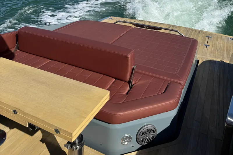 B-offline Yacht Photos Pics Luxurious seating on 2019 SACS Rebel 40 yacht with brown cushions and wooden table.