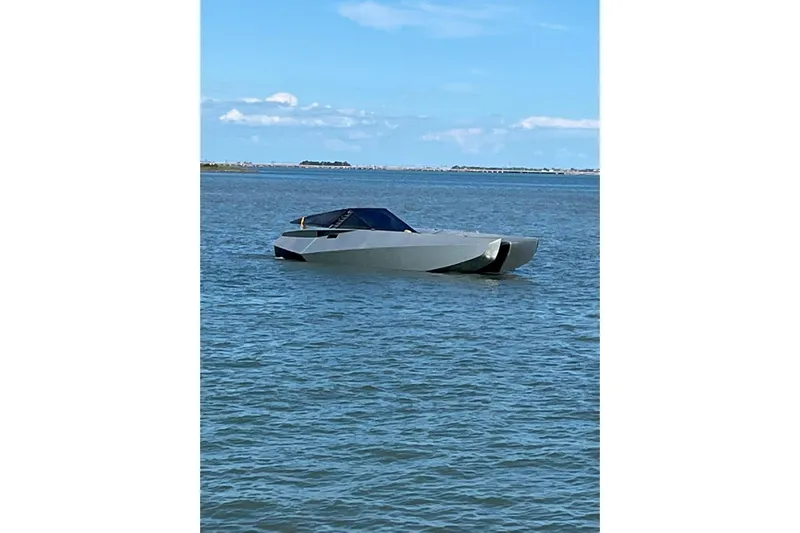 No Name Yacht Photos Pics 2025 Offshore Racing Code X boat on calm water under blue sky.