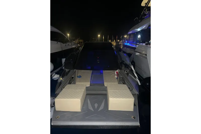 No Name Yacht Photos Pics 2025 Offshore Racing Code X boat docked at night with illuminated deck.